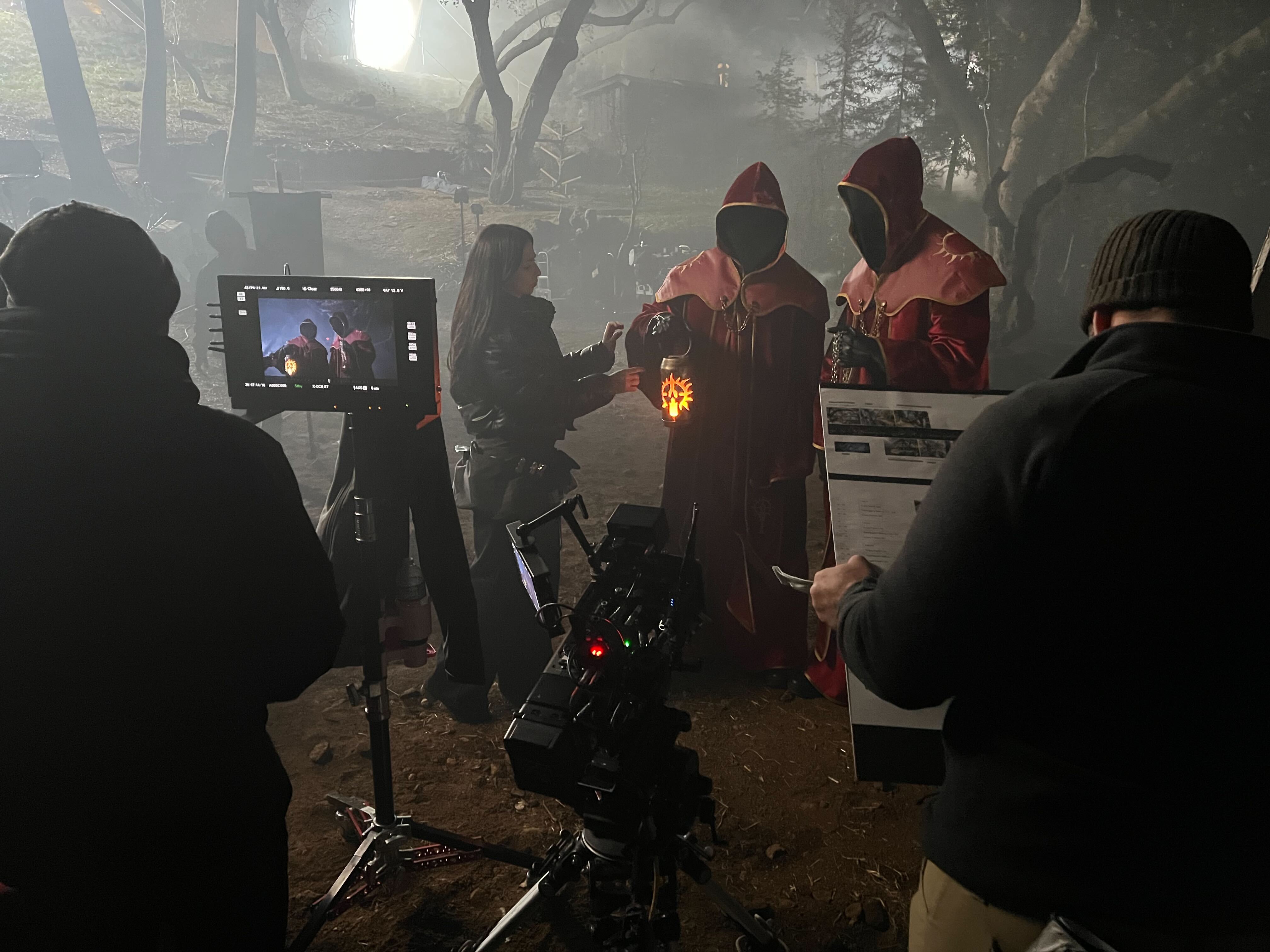 Crew adjusting a lantern held by a Diablo performer beside a camera and monitor